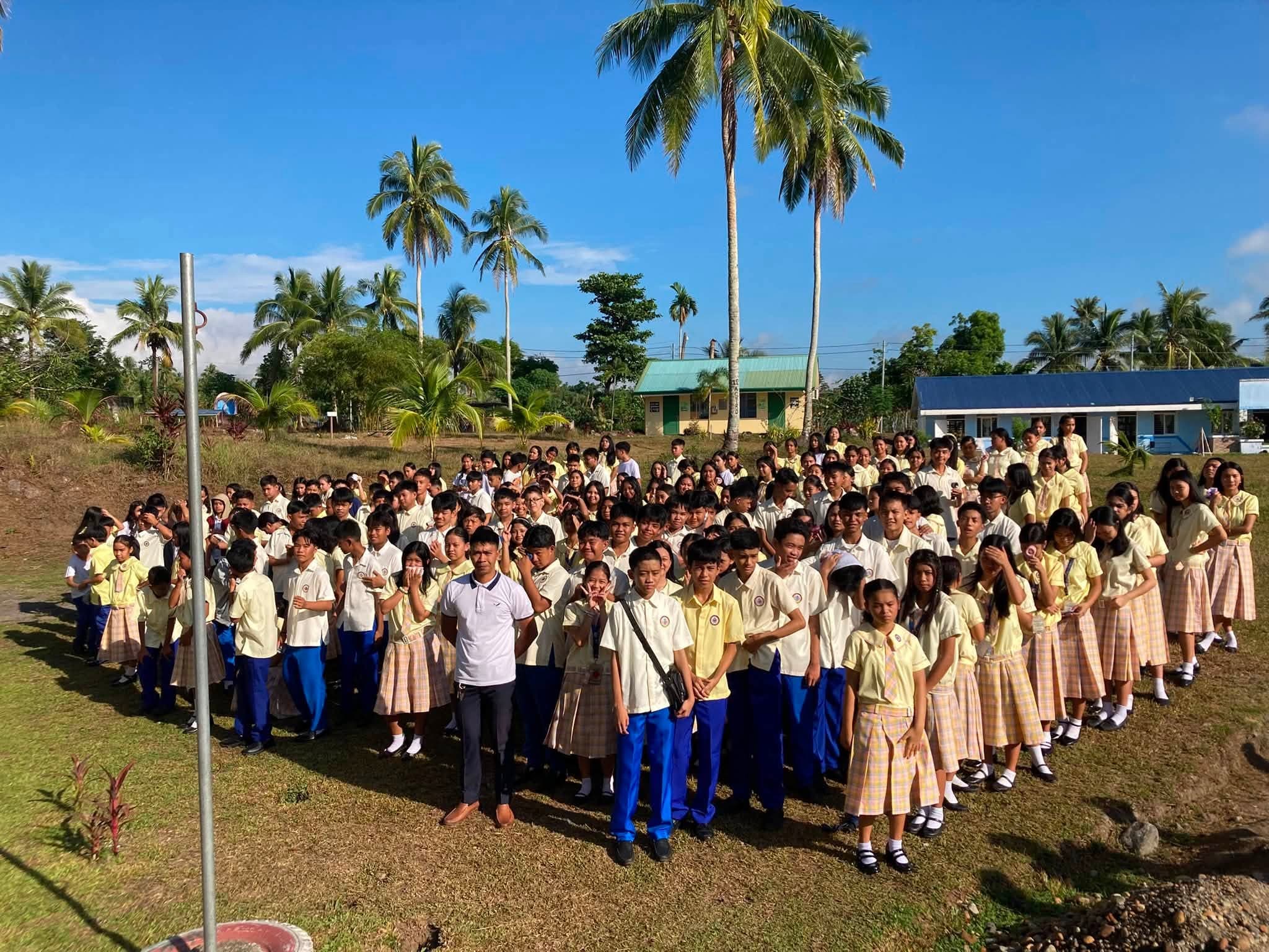 Junior high students in uniform assembled on the Goa Science High School grounds